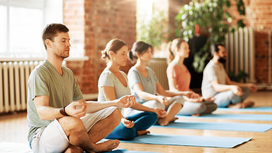 Individuals practicing yoga and meditation